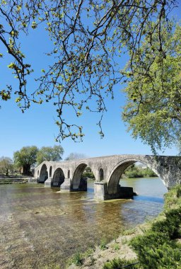 arta arched bridge in arahthos river greece in spring season