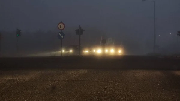 foggy road traffic lights cars moving in the morning in ioannina greece winter season