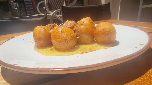 stock image loukoumades with honey in the plate  hot and fresh