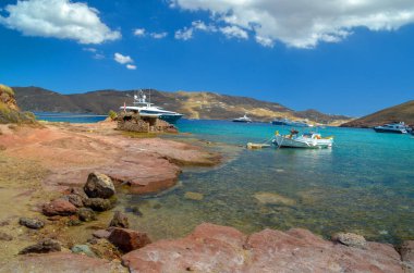 panormos beach and ships  in mykonos or mikonos island in greece   clipart