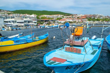 Fishing boats and coast guard boats in a yacht charter in the village of Sveti Vlas in Bulgaria against the backdrop of the sea and green hills. High quality photo