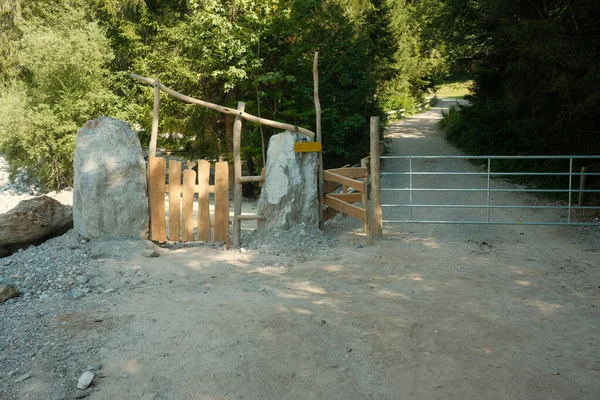 Wooden gate with heart carving and cattle gate in the Steinberge near Leogang in Austria.