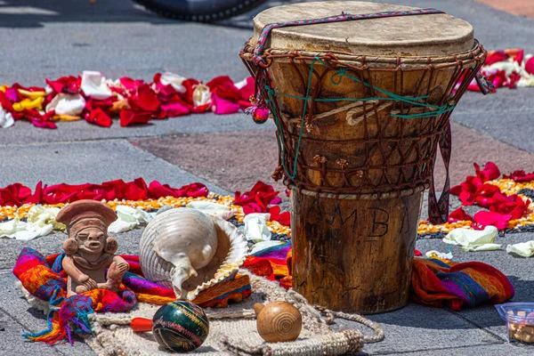 Details of an aboriginal ritual of the indigenous peoples of Andes. Andean cross, chakana or ceremony in honor of Pachamama (Mother Earth). Drum, sea shell, maracas. Ecuador