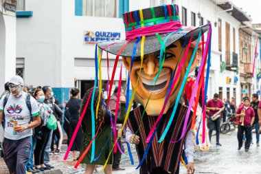 Cuenca, Ecuador - February 26, 2022: Carnival parade in the historic center of city Cuenca. Giant puppet as ecuadorian. Ecuador