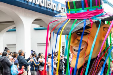 Cuenca, Ecuador - February 26, 2022: Carnival parade in the historic center of city Cuenca. Giant puppet as ecuadorian. Ecuador