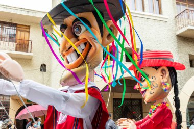 Cuenca, Ecuador. Parade during the carnival in the historic center of city Cuenca. Giant puppet in national costumes. 