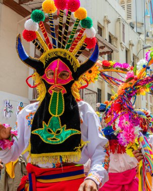 The carnival parade in Cuenca. Dancer dressed as folk character called Diablo Huma (Devil). Ecuador