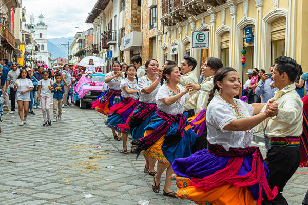 Cuenca, Ecuador - December 24, 2022: Pase del Nio Viajero Christmas procession in Cuenca. UNESCO cultural heritage. Folk dancers of  Azuay province in the historical center of the city