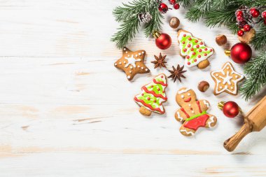 Christmas gingerbread with decorations on white wooden table. Christmas baking. Top view with copy space.