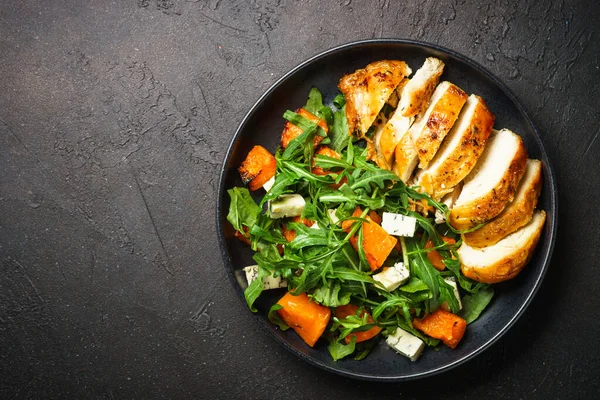 Chicken salad with pumpkin, blue cheese and arugula. Dash diet, keto diet meal. Top view image.