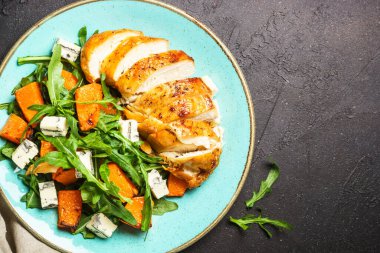 Fırında tavuk göğsü, balkabağı, mavi peynir ve roka ile sağlıklı salata. Sağlıklı diyet yemekleri.