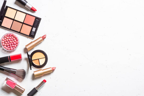 Make up products on white background. Shadow, lipstick, brushes. Flat lay image with copy space.