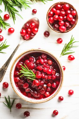 Beyaz ahşap masadaki bir kasede kızılcık sosu. Metin için boşluk olan üst görünüm.