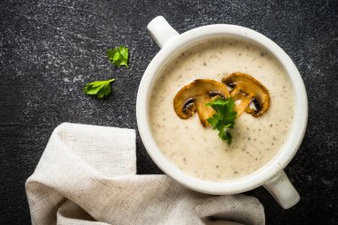 Koyu taş masada mantar çorbası. Sıcak sonbahar yemeği, kremalı çorba..