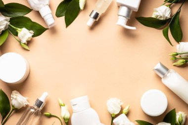 Natural cosmetic products. Cream, serum, tonic with green leaves and flowers. Skin care concept.