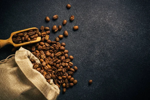 Roasted Coffee Beans Burlap Bag Black Top View Copy Space — Fotografia de Stock