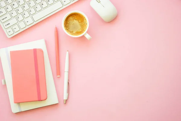 Office workspace. Woman flat lay pink creative layout freelance office desk.