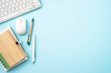 Office desk flat lay background with laptop, notepad and pen.