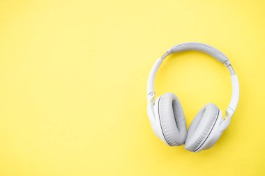 Wireless Headphones on color background. Flat lay with copy space.