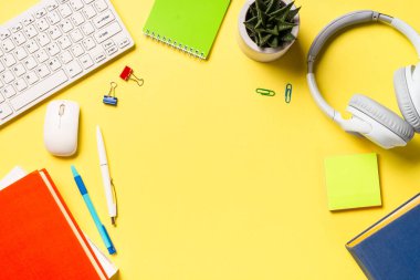 Office desk with laptop, headphones, notepad and pen. Flat lay image with copy space. Office, studying, workspace.