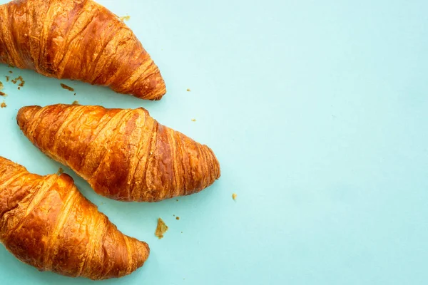 stock image Croissant at blue background. French bakery. Flat lay image with copy space.