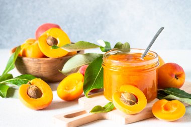 Apricot jam in glass jar with fresh apricots. Homemade preservations.
