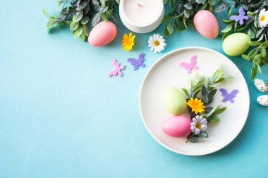 Paskalya sofrası, paskalya yemekleri. Yumurtalı beyaz tabak ve tatil süslemeleri..