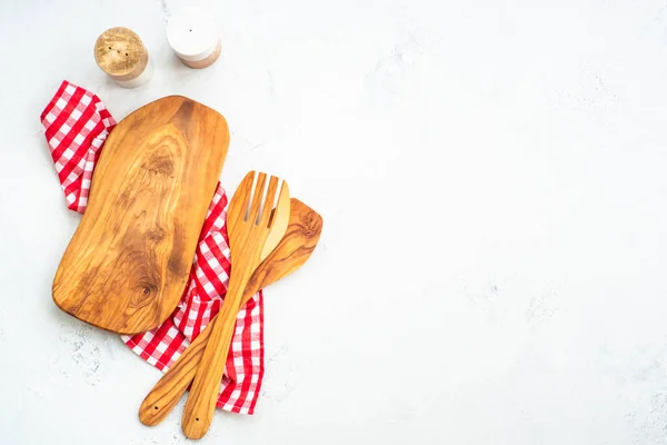 stock image Olive board, utensils and tablecloth on white kitchen table. Food background with copy space.