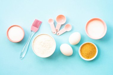 Mavinin üzerinde pişirme arka planı. Pişirme malzemeleri, ev yapımı tarifler. Un, şeker, yumurta ve çatal bıçak. Üst görünüm.