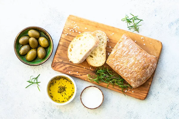 Ciabatta Bread Wooden Board Olive Oil Olives Herbs Top View — Stock Photo, Image