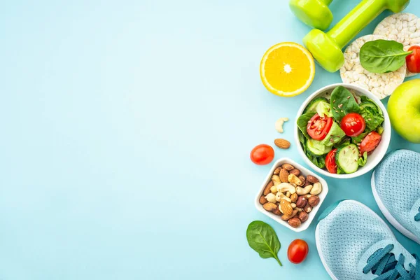 stock image Healthy lifestyle and diet food background. Sport shoes, dumbell and healthy food on blue. Flat lay with copy space.