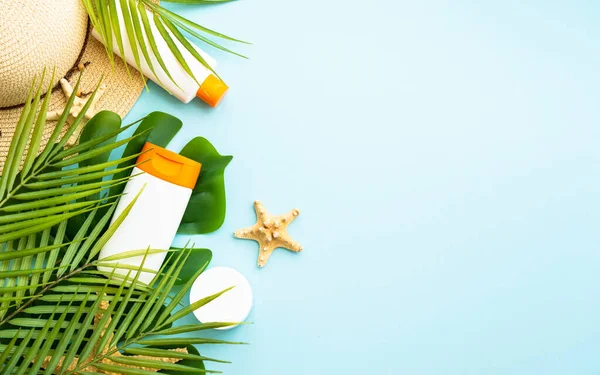 stock image Sun screen products on tropical background with green leaves. Sun protection and summer holidays. Flat lay image with space for text.