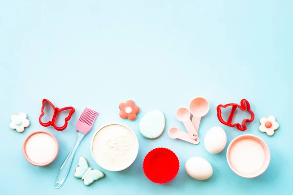 stock image Easter baking, Flour, edds, sugar and gingerbread cookies. Top view on blue.