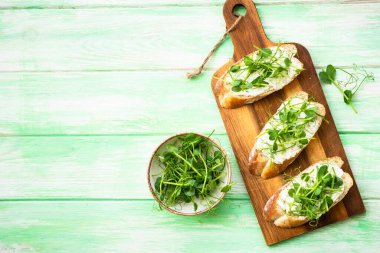Krem peynirli tost ve mikro yeşillik. Sağlıklı yiyecekler, vejetaryenler, doğal vitaminler. Üst görünüm.