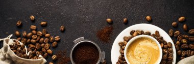 Coffee cup and coffee beans at dark table . Long banner format. clipart