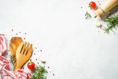 Kitchen utensil with herbs and vegetables. Healthy food background. Top view on white background.