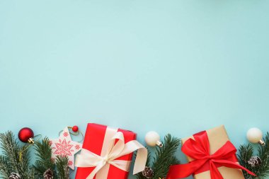 Noel hediyesi ve arka planda kırmızı süslemeler. Kopyalama alanı olan düz resim.