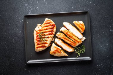 Siyah arka planda tavuk bifteği ızgarası. Kopyalama alanı olan düz.