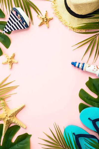 Summer flat lay background. Palm leaves, sea shells and accessories on pink.