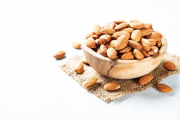 stock image Almond nuts at white background. Healthy vegan food, omega 3.