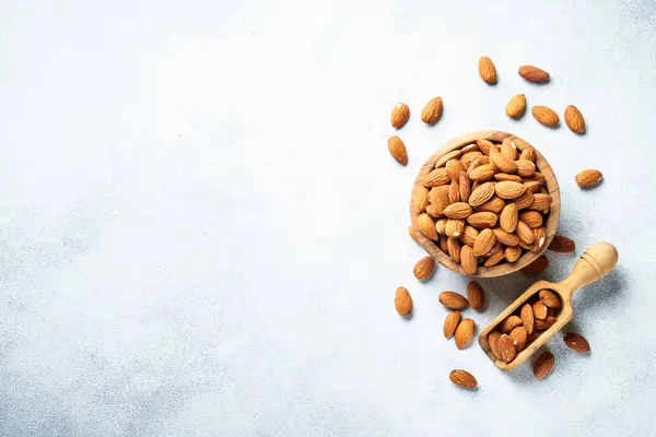 stock image Almond nuts at white background. Healthy vegan food, omega 3 sources. Flat lay with copy space.