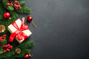 Siyah Noel arka planında yatıyordu. Şimdiki kutulu tatil süslemeleri ve siyahlı noel ağacı ve kopya alanı.