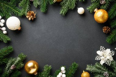 Siyah arka planda Noel süslemeleri ve çam ağacı. Kopyalama alanı olan düz.