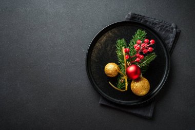 Christmas food. Christmas decorations with holiday dishes on black. Flat lay with copy space. clipart