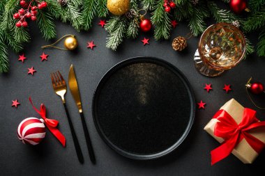 Noel yemeği. Noel süsleri ve siyah tabaklar. Kopyalama alanı olan düz.