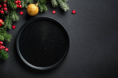 Noel masası. Noel yemeği, siyah üzerine zarif süslemeler olan bayram yemekleri. Kopyalama alanı olan düz.