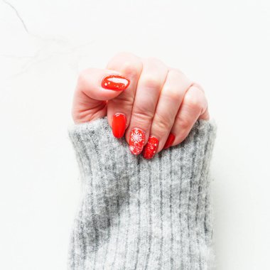 Noel manikürü, beyaz arka planda güzel kırmızı tırnaklar. Tasarım için alanı olan üst görünüm.