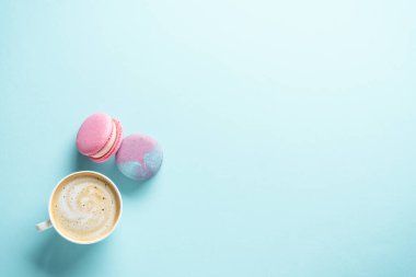 Mavi arka planda bir fincan kahve ve kurabiye. Kopyalama alanı olan düz.