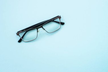 Glasses on blue. Bad vision.