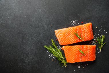 Baharatlı çiğ somon filetosu. Siyah arkaplanda üst görünüm.